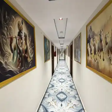 Art-lined corridor with Krishna and horse paintings at Hotel Maruti R Ambli Bopal
