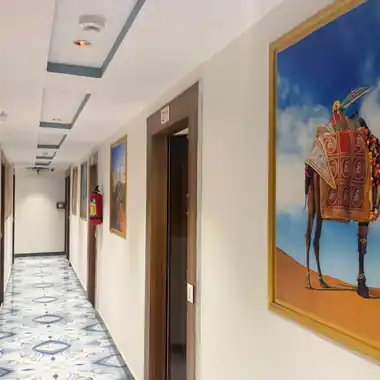 Guest-room corridor with Rajasthani camel art at Hotel Maruti R Ambli Bopal