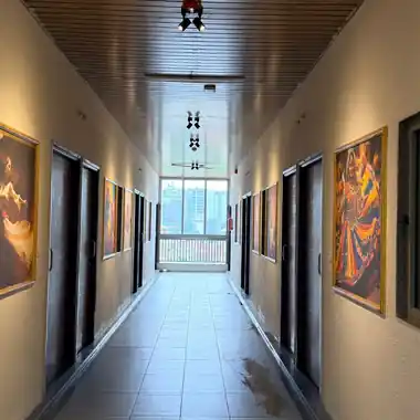Art-lined guest room corridor at Hotel Maruti R South Bopal