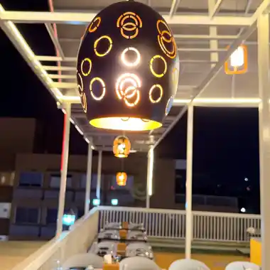 Hanging lantern over dining tables at the Hotel Maruti R South Bopal rooftop restaurant