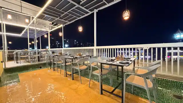 Lantern-lit rooftop terrace seating at Hotel Maruti R South Bopal, Ahmedabad
