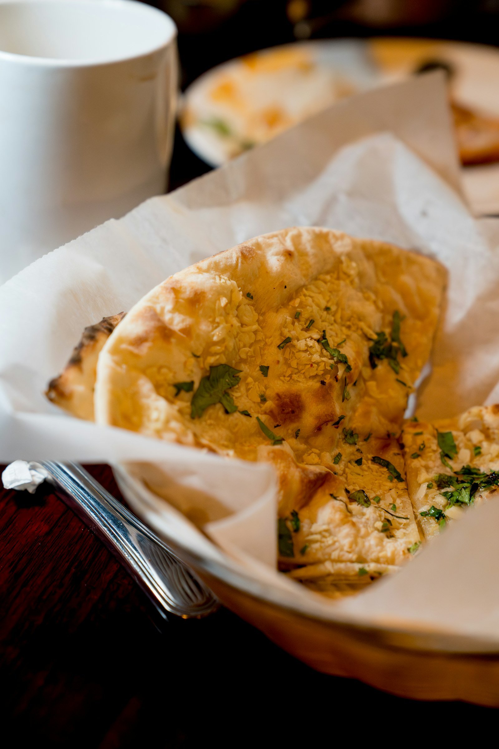 Basket of warm tandoori naan at Maruti R Restaurant & Cafe